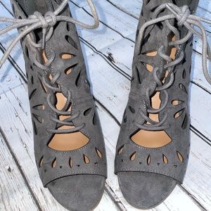 Blue suede lace up open toe booties.